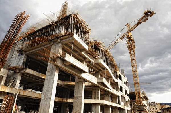 Construction site with tower crane and building under construction