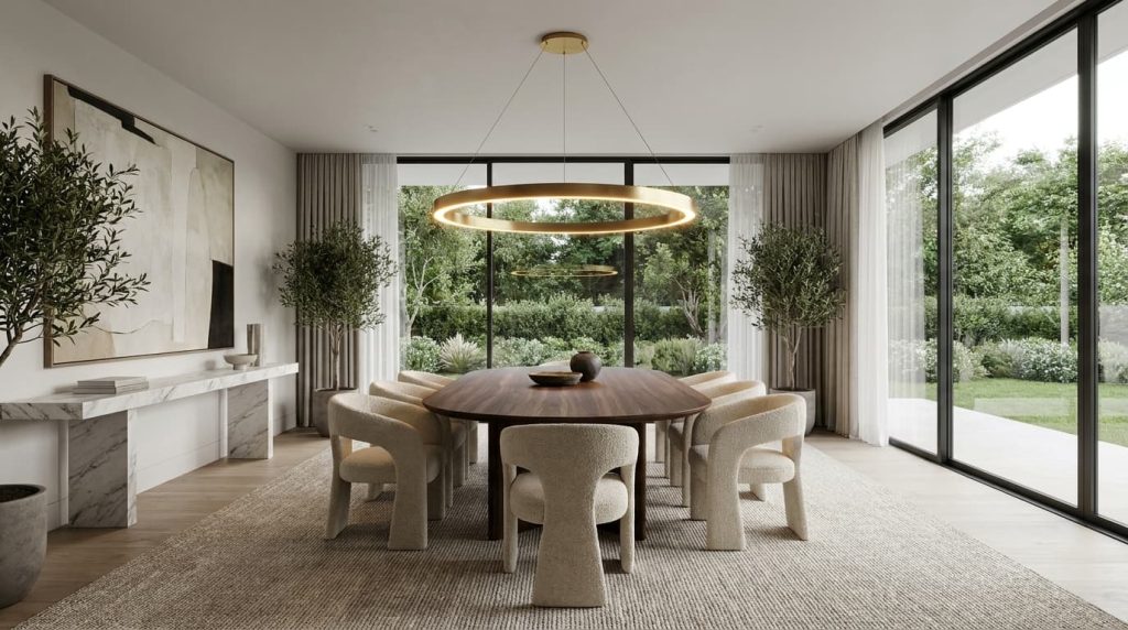 Modern dining room with a large wooden table, eight beige chairs, a striking modern dining room light fitting in the form of a circular chandelier, two potted trees, abstract wall art, and floor-to-ceiling windows overlooking a green garden.